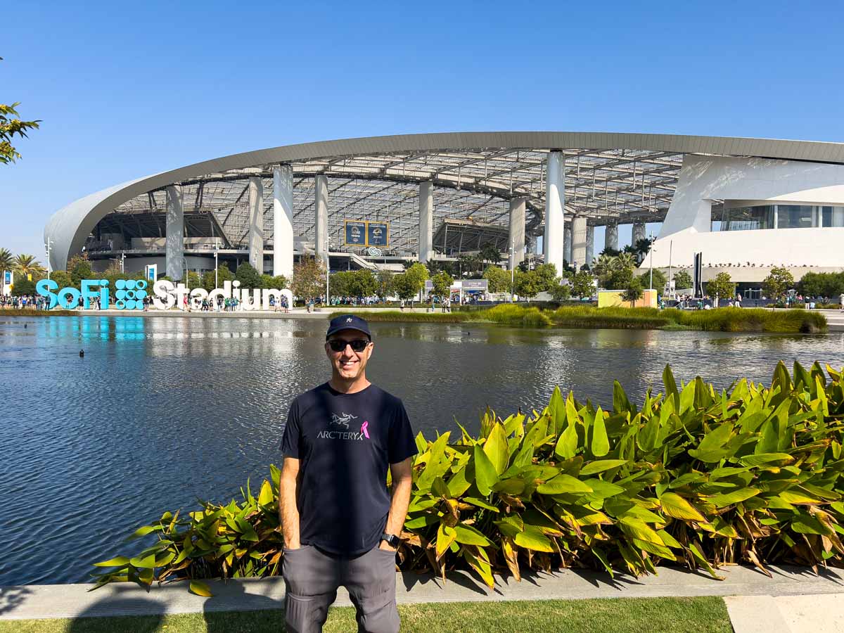 Dan Brewer, owner of the Ultimate Sports Road Trip travel blog, explores Lake Park at SoFi Stadium prior to an LA Rams home game.