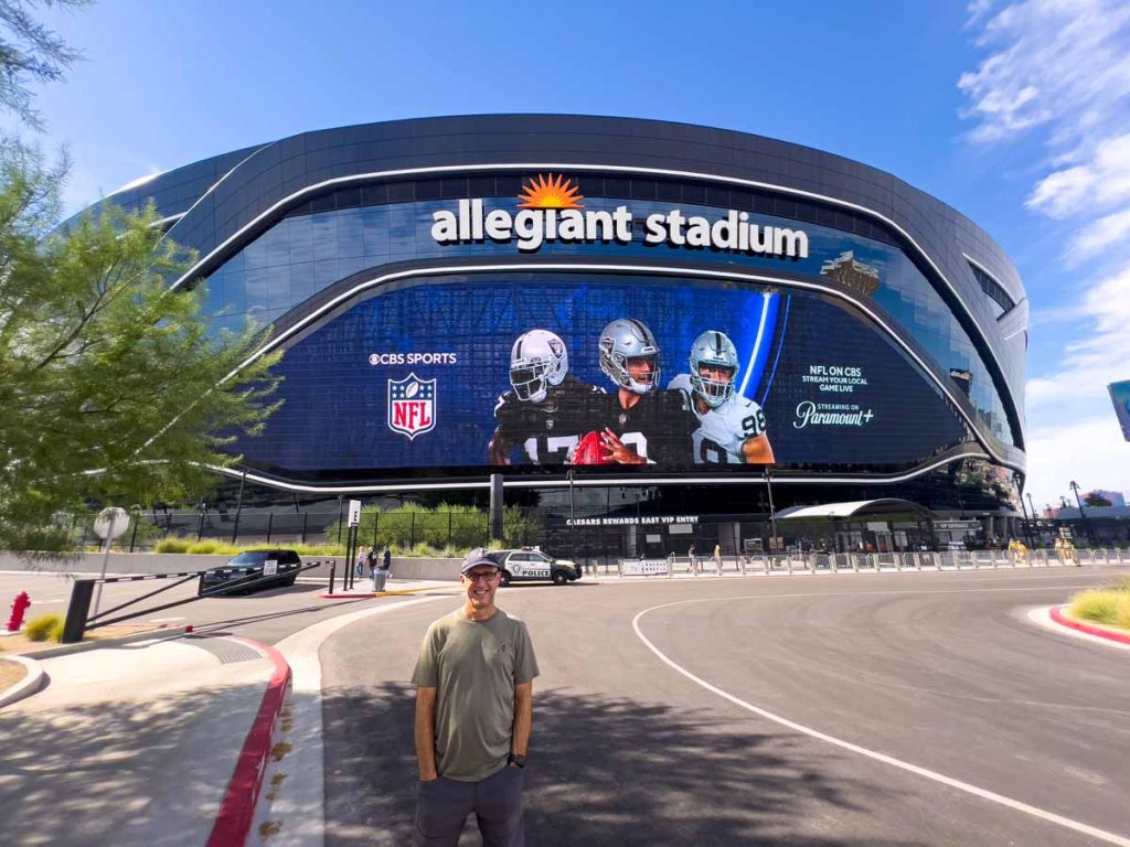 Dan Brewer, owner of the Ultimate Sports Road Trip blog, stands in front of Allegiant Stadium before a Raiders vs Packers game on Monday Night Football.