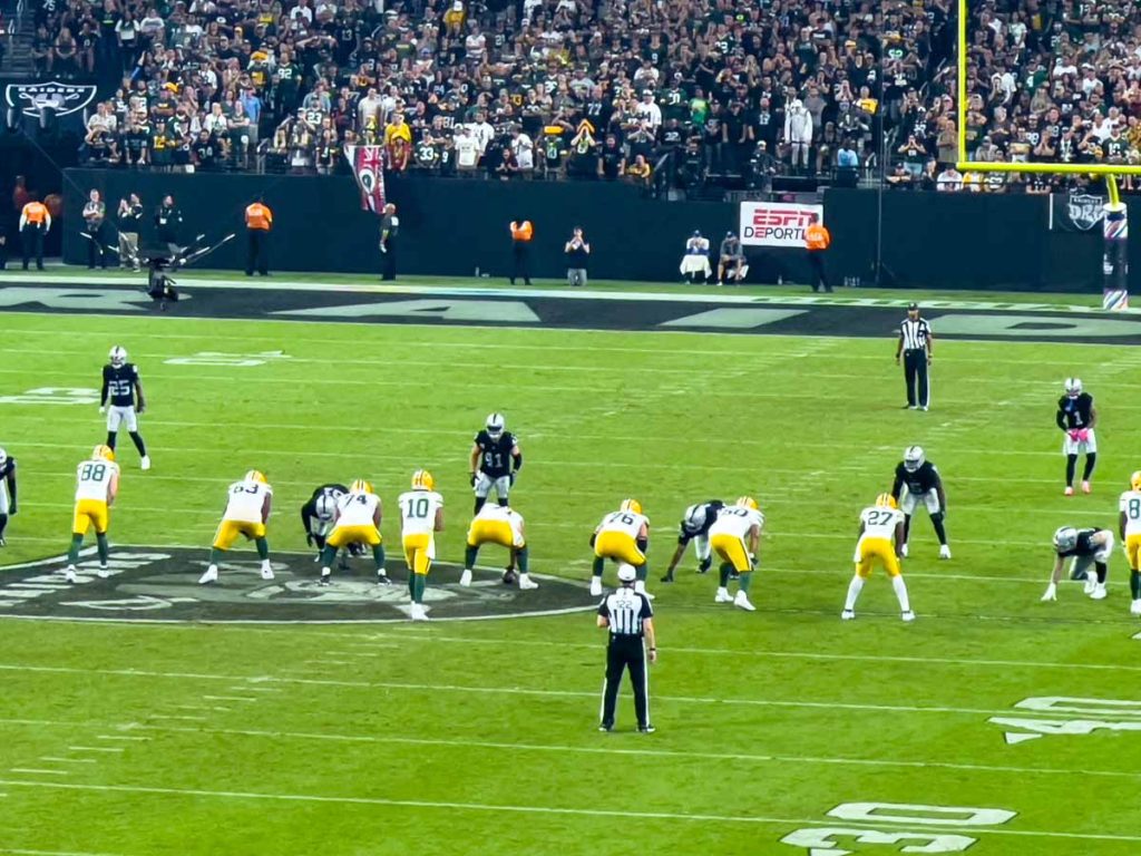 Jordan Love, quarterback of the Green Bay Packers, is about to run a play against the Las Vegas Raiders on Monday Night Football.