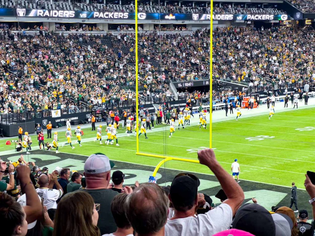 Green Bay Packers fans cheer as the team takes the field to play the Las Vegas Raiders.