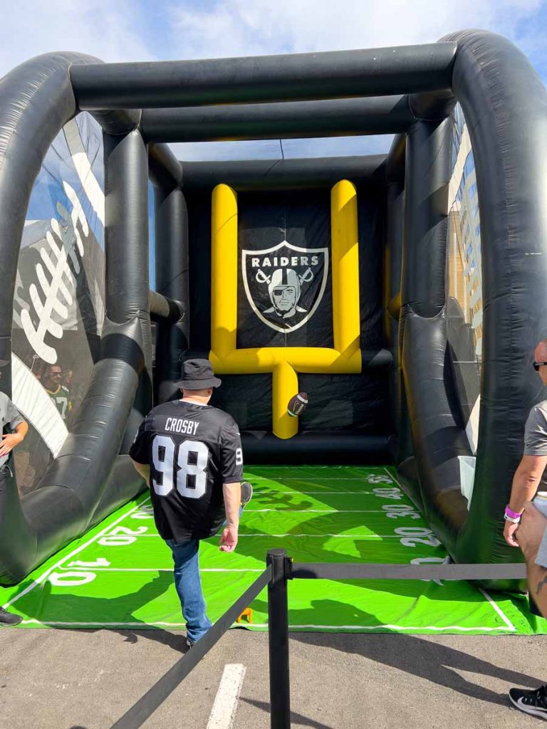 a Raiders fan kicks a field goal at the Modela Tailgate Zone prior to a primetime game.