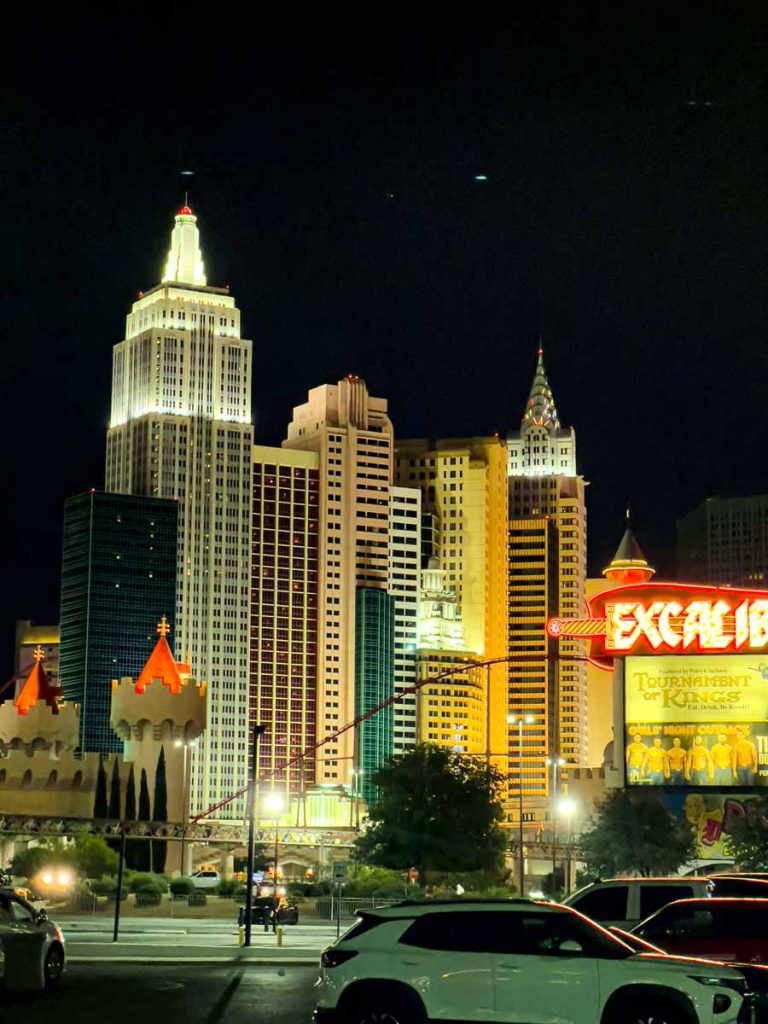 The New York New York casino hotel is all lit up at night after a Raiders primetime game.