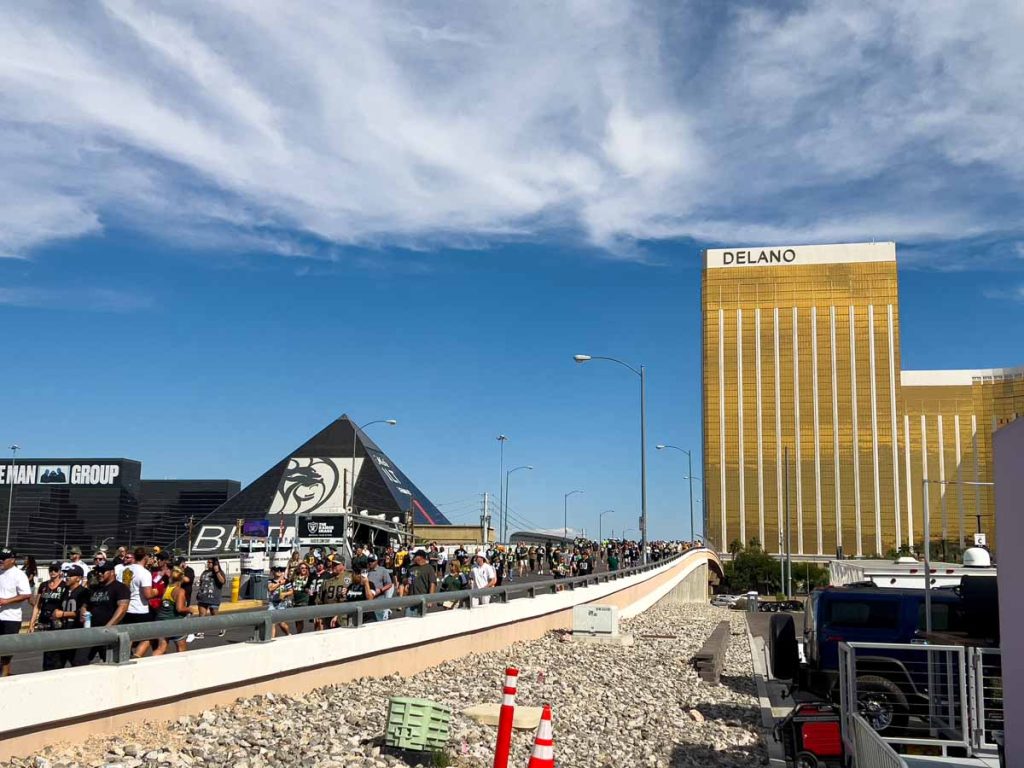 a crowded pedestrian bridge runs from the Las Vegas Strip to the Allegiant Stadium in Las Vegas, NV.
