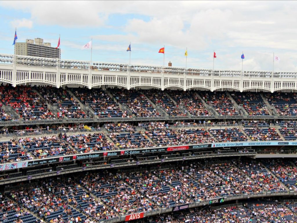 The many levels of Yankee Stadium in the Bronx, NY are filled with fans watching an MLB game.