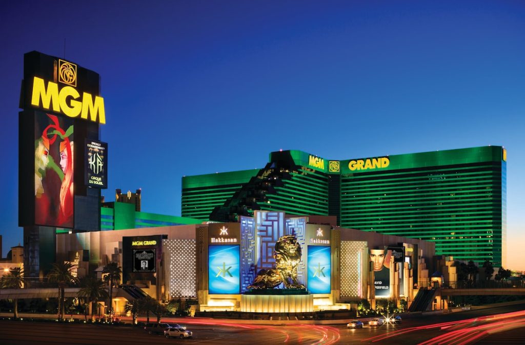 The MGM Grand hotel is lit up in its distinctive green color on the Las Vegas strip at night.