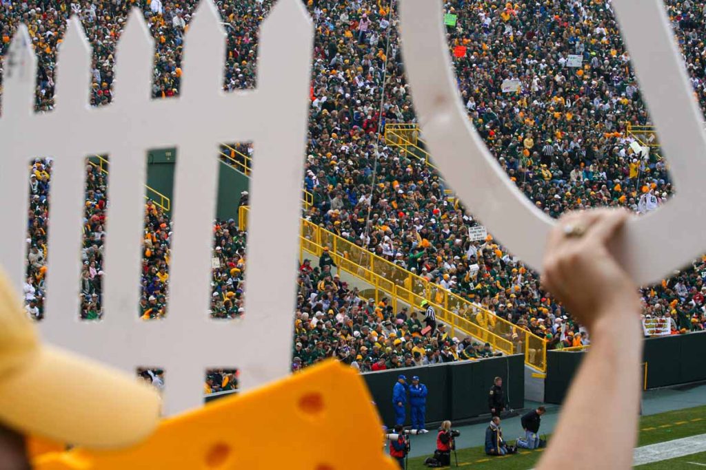 A D-Fence sign is held up at a Green Bay Packers game at Lambeau Field.