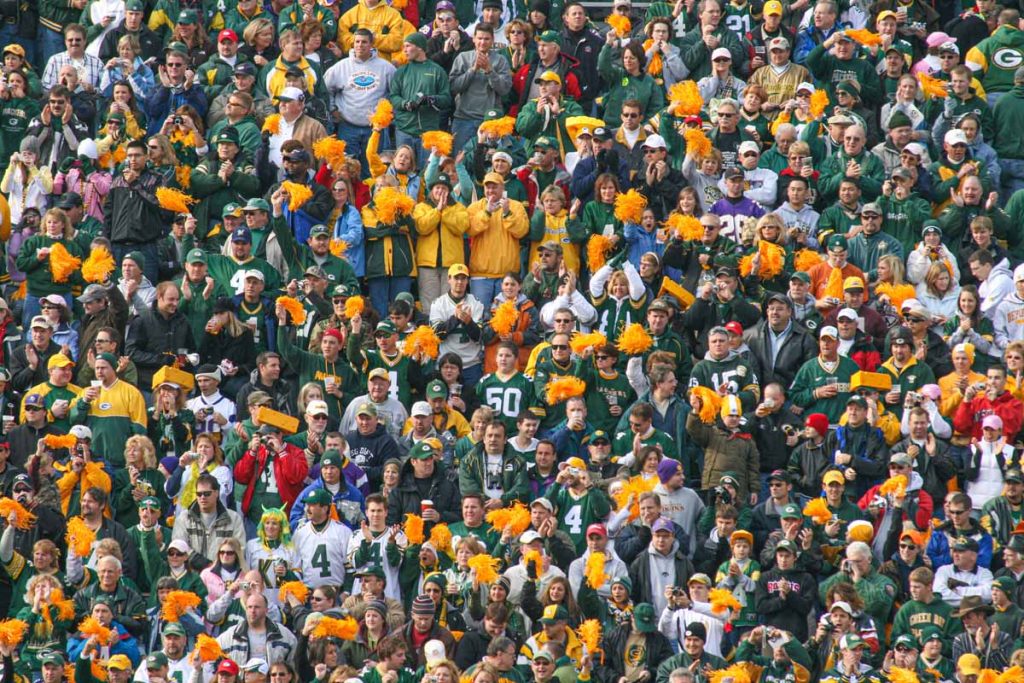 A picture of the crowd at Lambeau Field shows how people dress for a Green Bay Packers game.