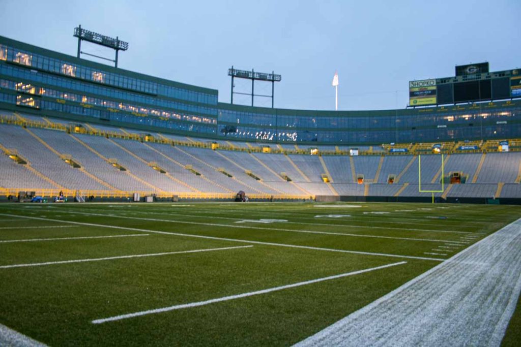 Lambeau Stadium is lit up at dusk. View from the end zone while on a Lambeau Stadium Tour.