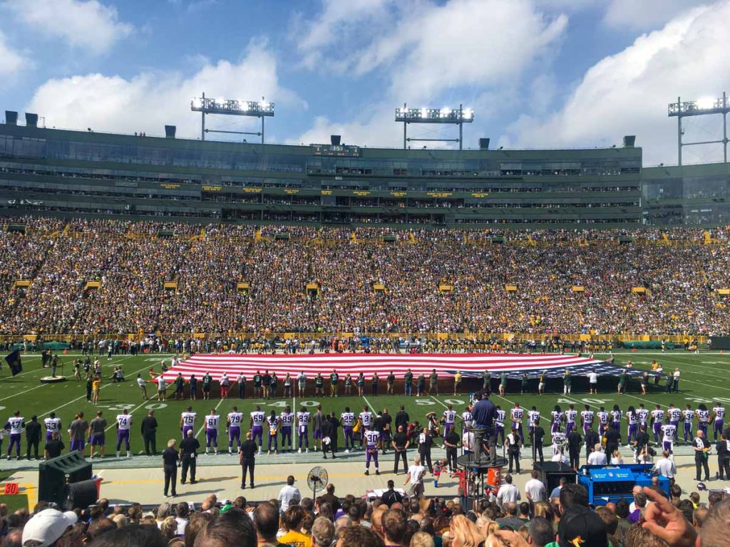 A massive USA flag is displayed mid-field on Lambeau Field before a Green Bay Packers home game.