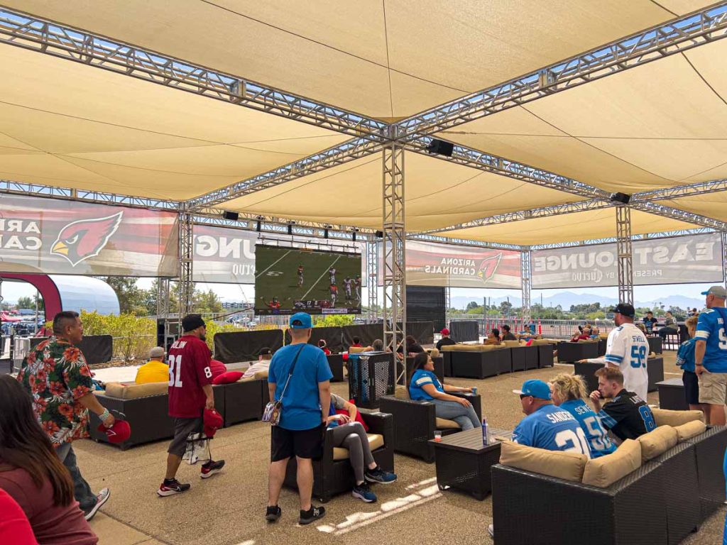 Football fans check out the early NFL games on the big screen in the Flight Deck - outside State Farm Stadium.