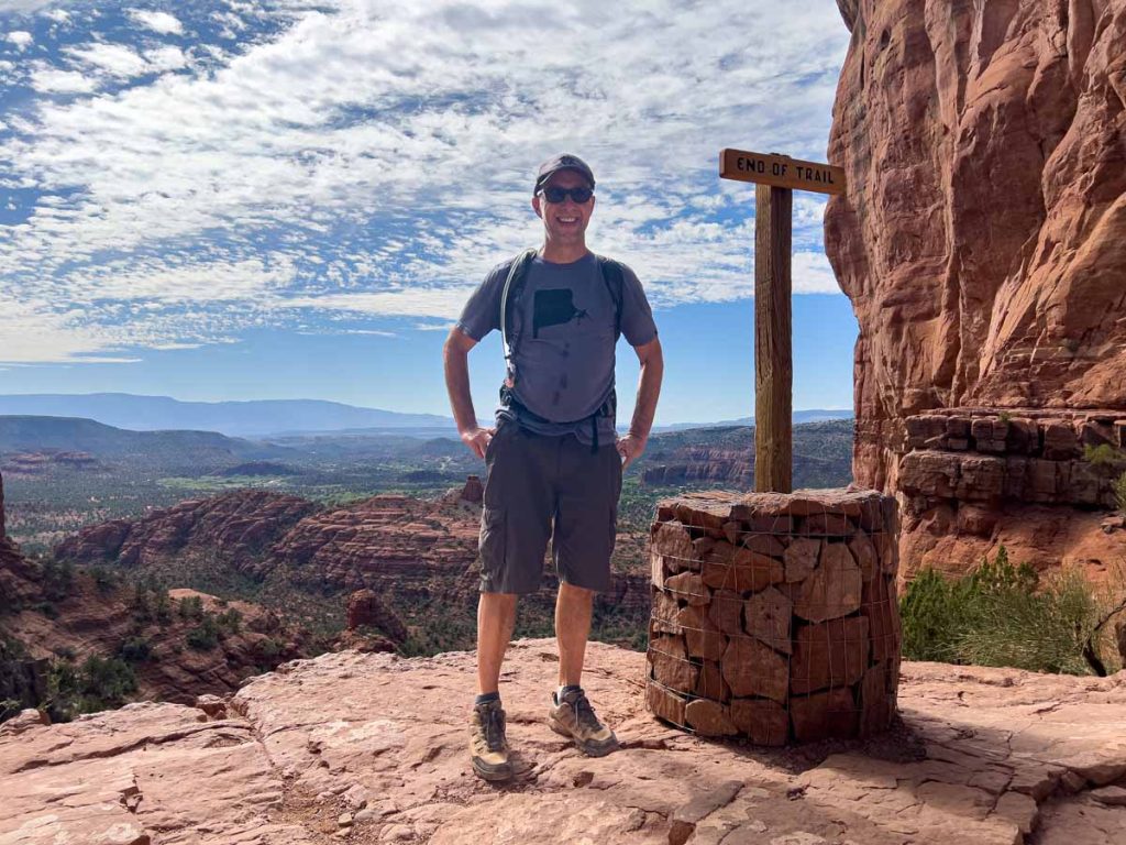 Dan Brewer, owner of UltimateSportsRoadTrip.com, stands at the viewpoint at the end of the Cathedral Rock Trail in Sedona, AZ.